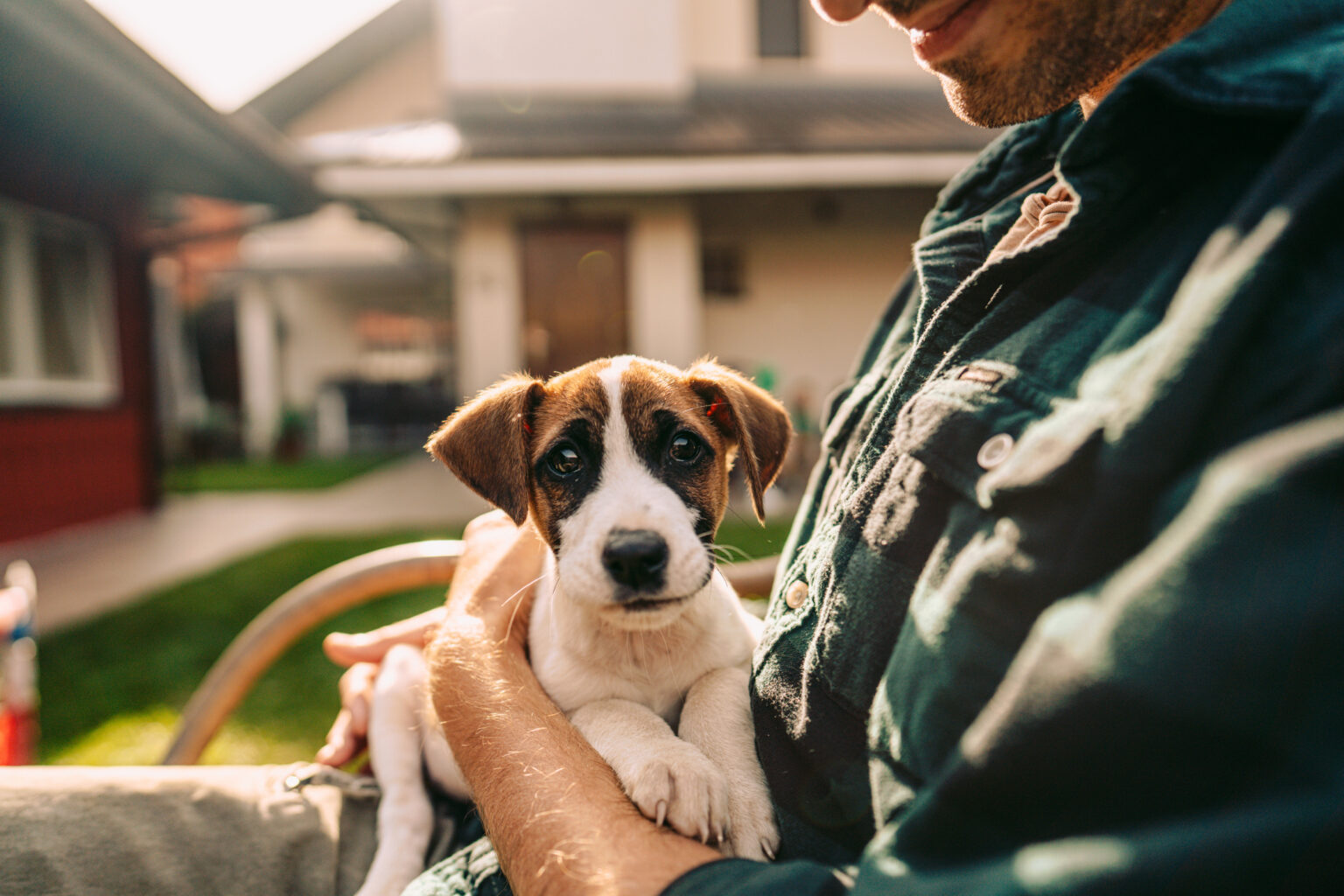 Photo of man and his puppy in a yard